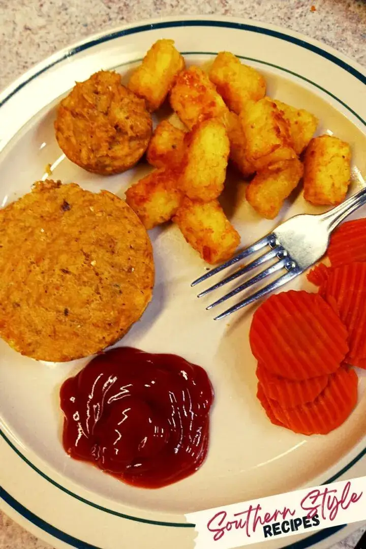 plated up salmon patties with tater tots and carrots