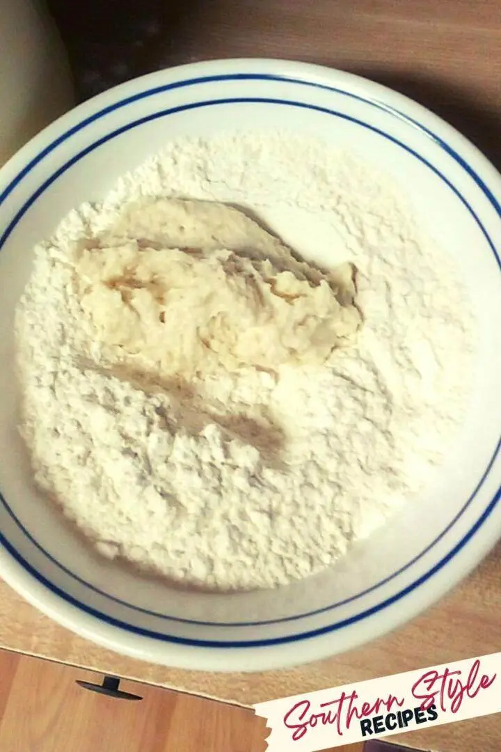 dollop of biscuit dough in flour bowl